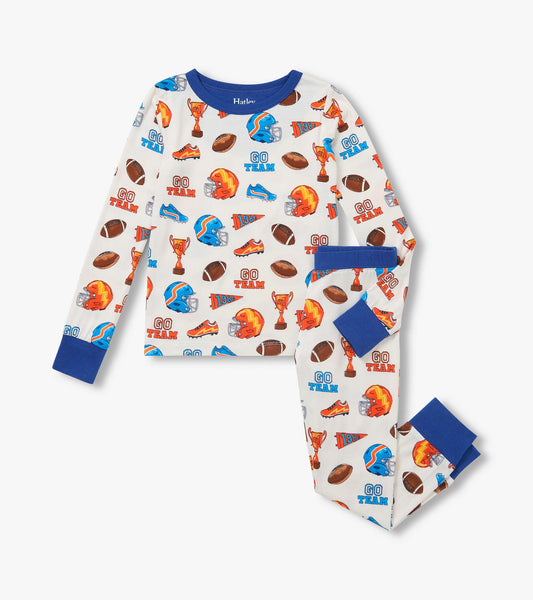 Kids pajama set with blue trim and sports print of helmets, footballs, trophies, shoes and pennants