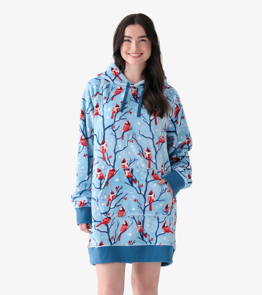 Model wearing oversized light blue fleece hoodie dress with red cardinals, branch print, hood and front pocket