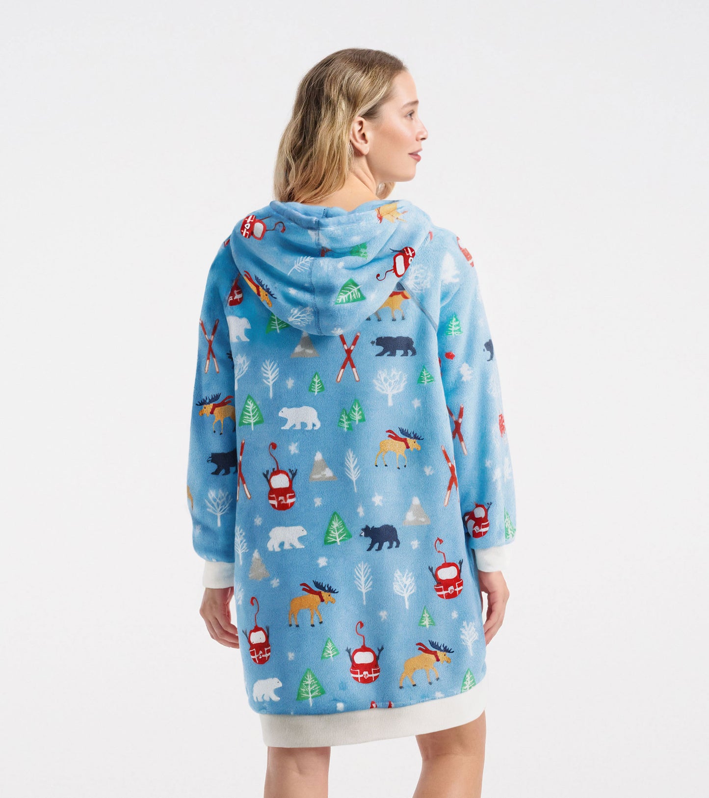 Oversized fleece hoodie in light blue with colorful winter-themed patterns, featuring a hood and long sleeves.