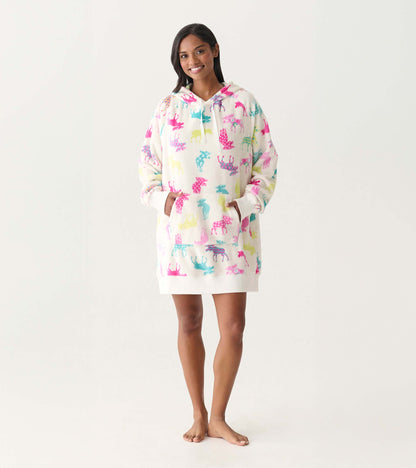 White oversized hoodie dress with colorful moose print, hood, front pocket, and long sleeves on a model