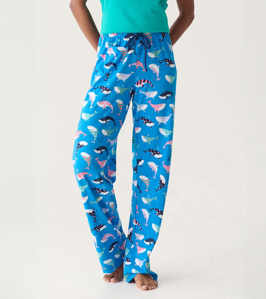 Blue cotton pajama pants with colorful whale print, drawstring waist, and straight-leg fit on model