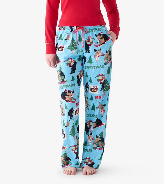 Close-up of light blue pajama pants with red drawstring and Christmas bear, moose, tree, and gift print