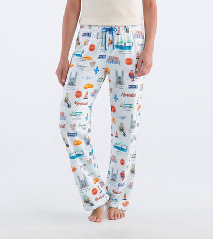 Front view of white Montreal pajama pants with blue drawstring and colorful city landmark print