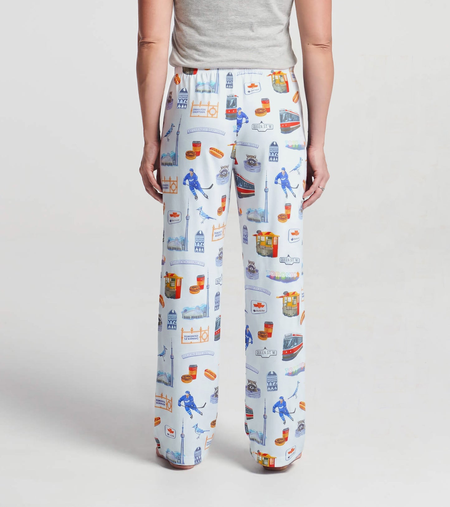 Back view of women's white pajama pants with all-over Toronto landmark and streetcar print