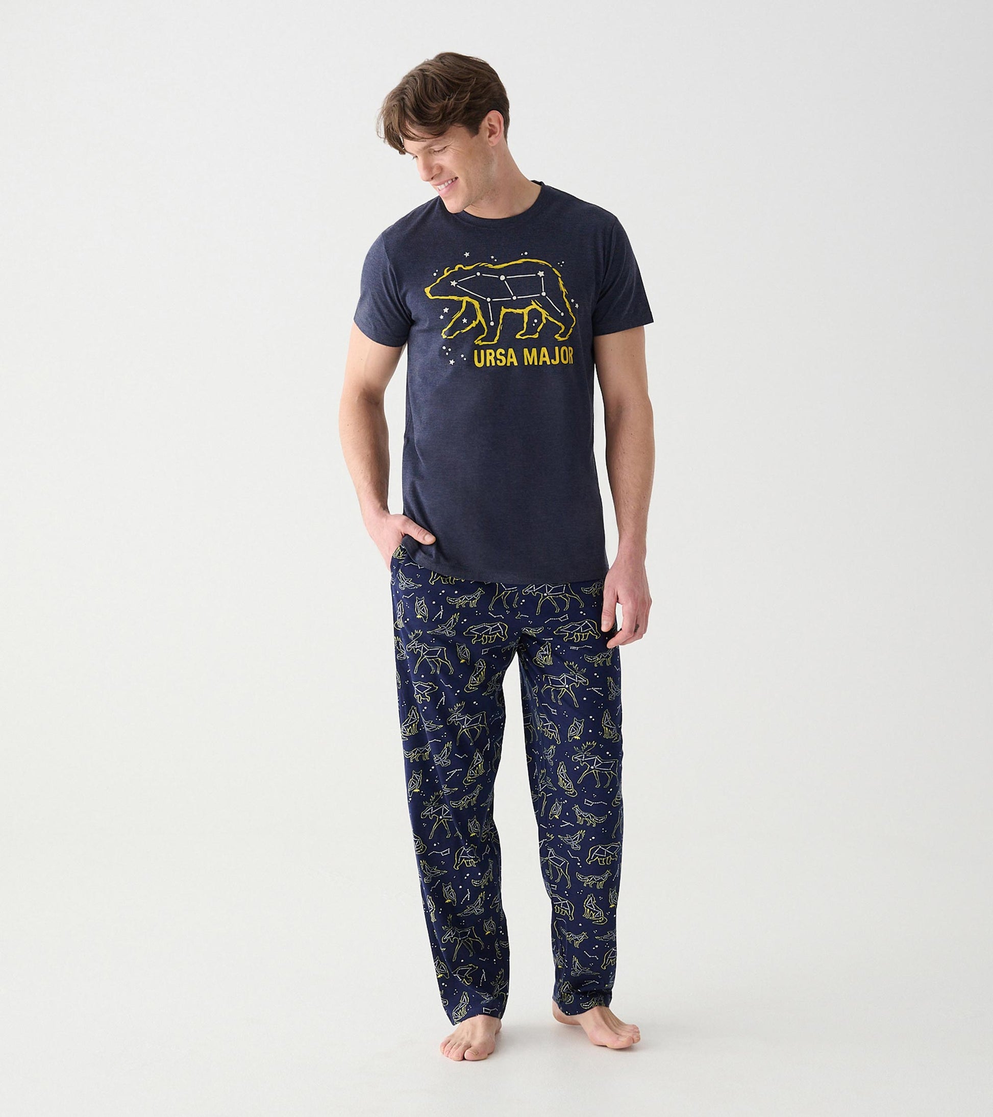 Model wearing navy animal constellation pajama pants with a matching Ursa Major graphic tee
