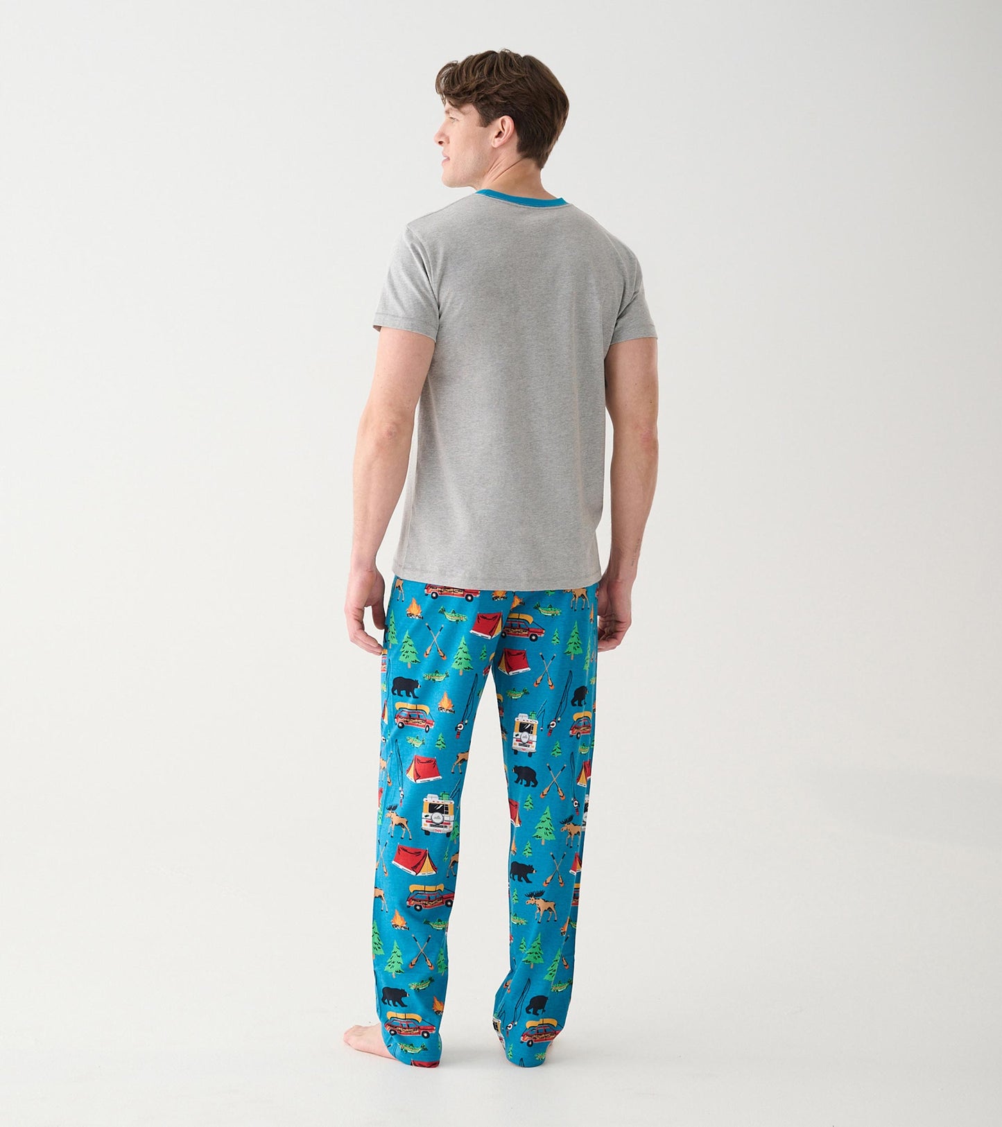 Back view of model wearing blue camping print pajama pants with a gray ringer T-shirt