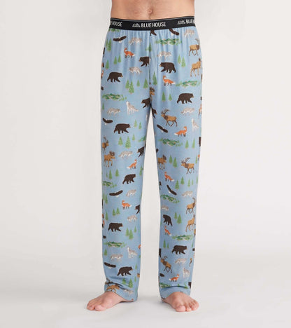 Front view of light blue pajama pants with bears, moose, foxes, wolves, trees and streams