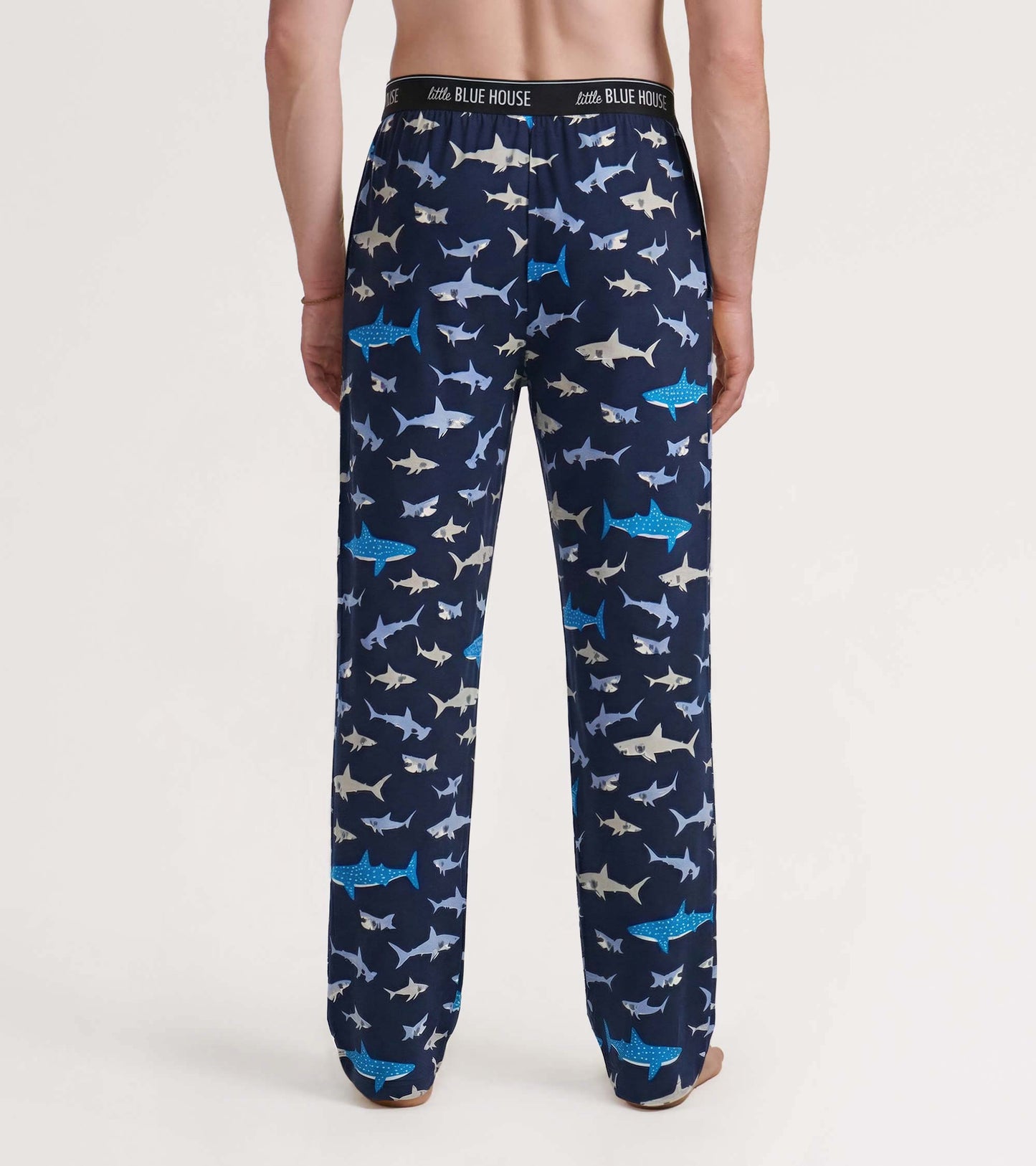 Men’s navy pajama pants with allover shark print, shown from the back with elastic waistband and straight legs