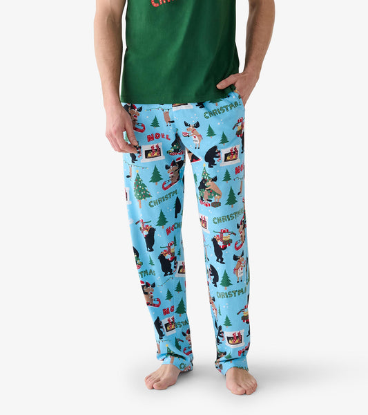 Close view of blue Christmas pajama pants with bears, moose, trees, fireplaces and holiday words