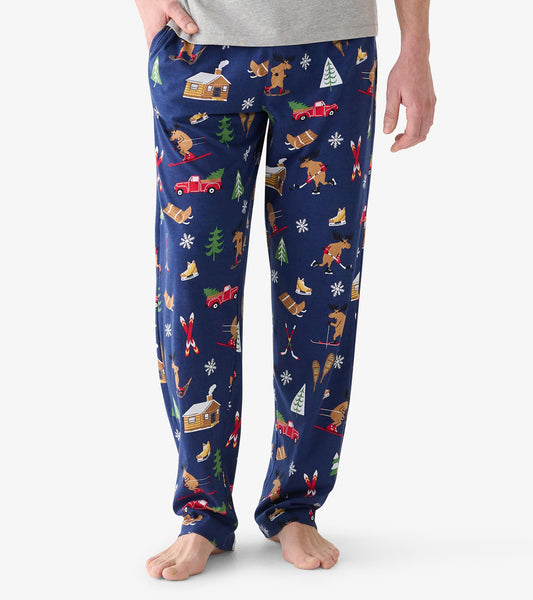 Close-up of navy pajama pants with moose, cabins, red trucks, trees, snowflakes and winter sports print