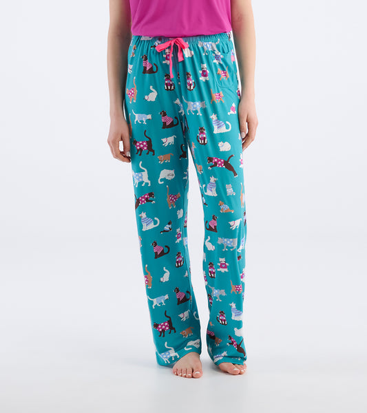 Close-up of teal pajama pants with colorful cat print, pink drawstring waist, and side pocket