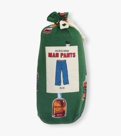 Green pajama pants with bourbon bottle print and a front label graphic, folded and tied with a white ribbon.