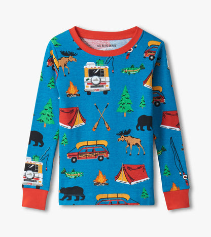 Blue long-sleeve kids pajama top with red trim and allover camping print of tents, trees, bears, moose, fish, and vans