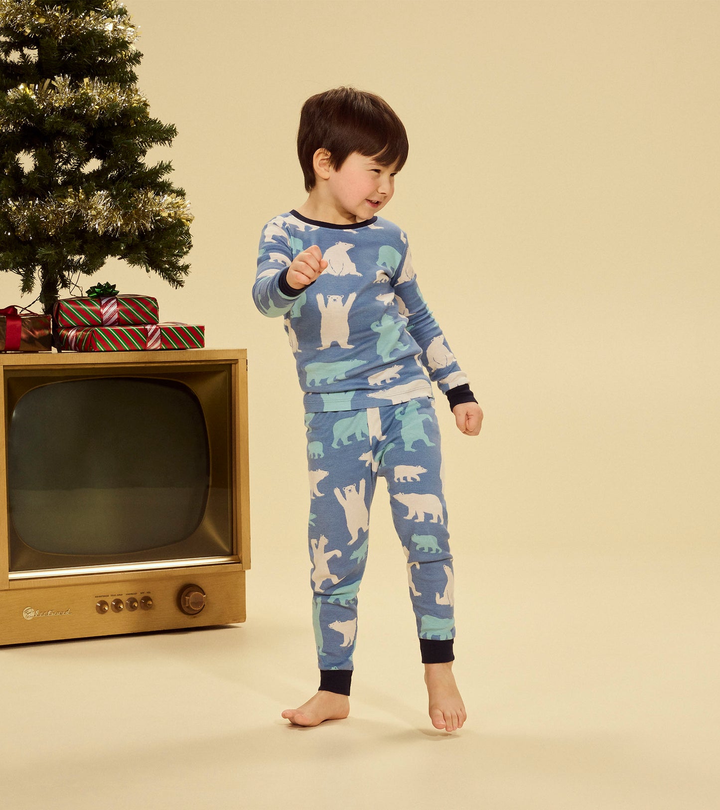 Blue pajama set featuring playful polar bear patterns, designed for kids, with long sleeves and pants.