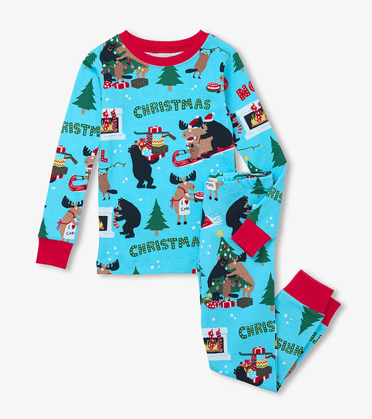 Kids Christmas pajama set in blue with red cuffs and holiday animal print on top and pants
