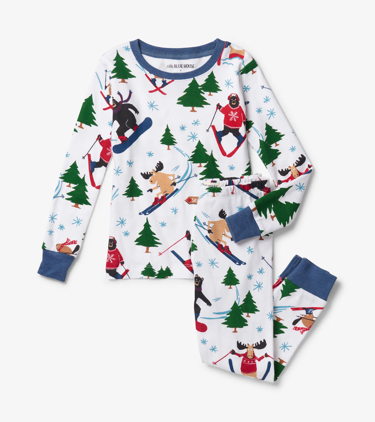 Kids pajama set laid flat in white with blue trim and skiing bear, moose, tree and snowflake print