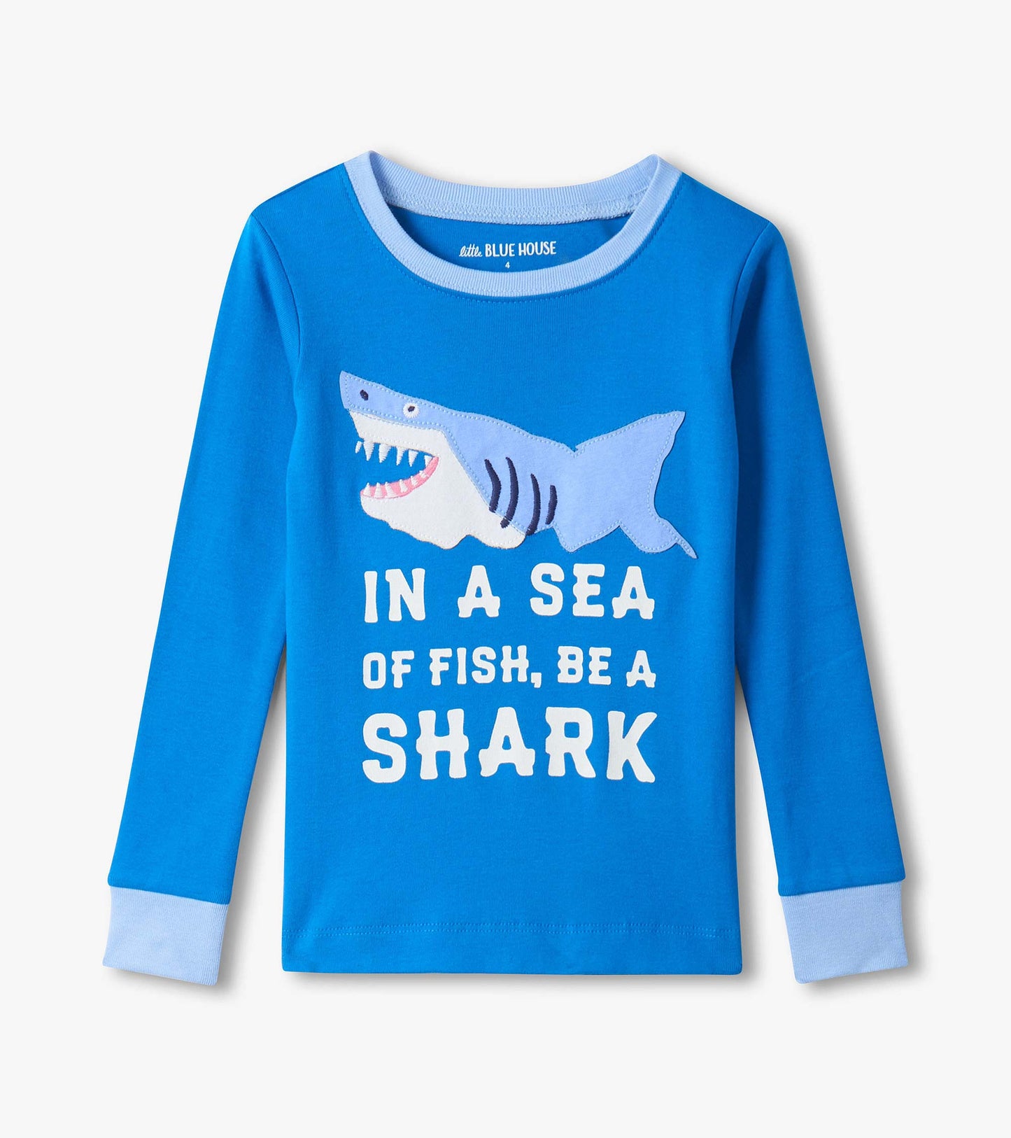 Blue long-sleeve kids pajama top with light blue cuffs and shark graphic with “In a sea of fish, be a shark” text