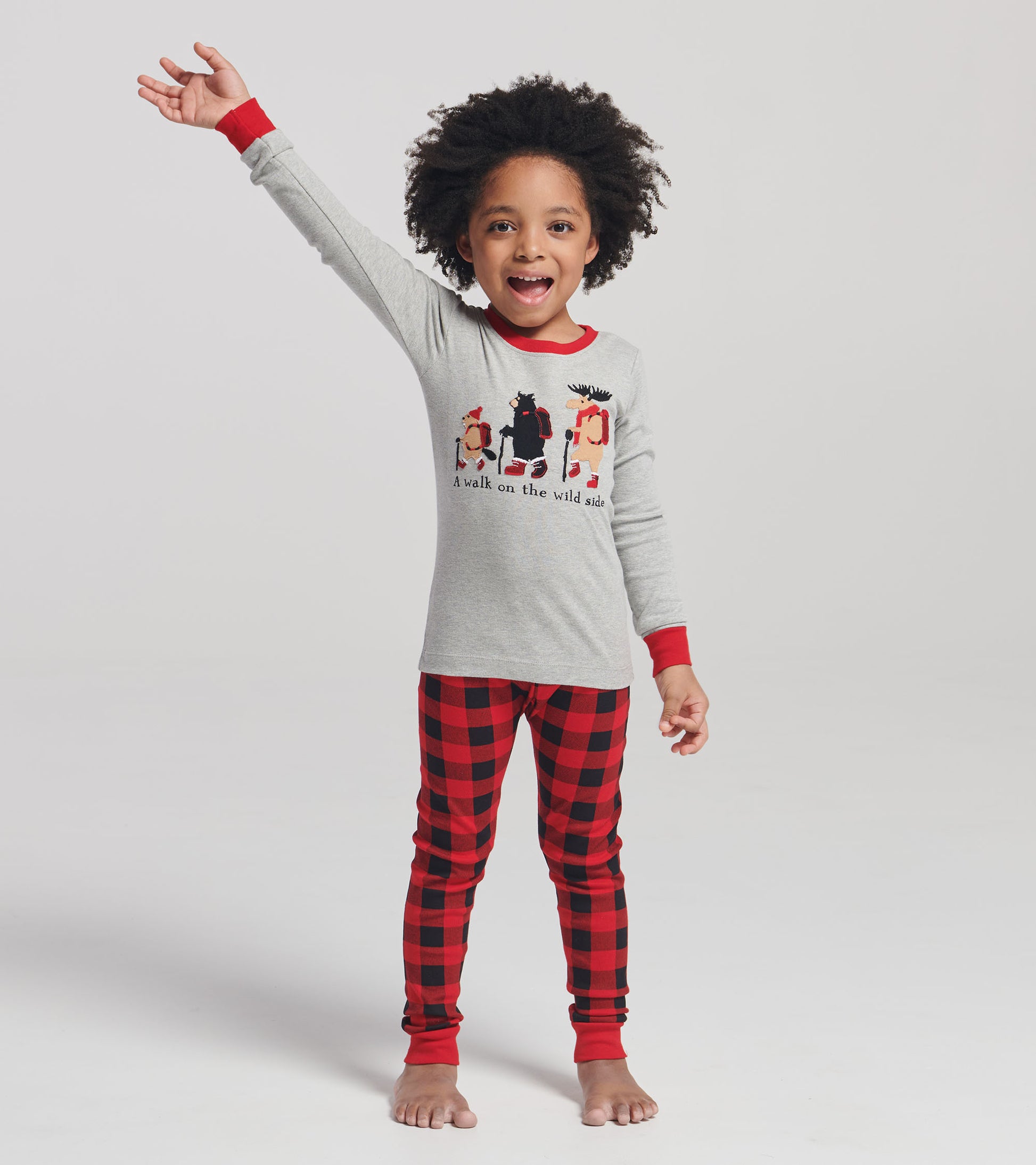 Gray long-sleeve top with red accents and playful animal appliqués, paired with red and black plaid pajama pants.