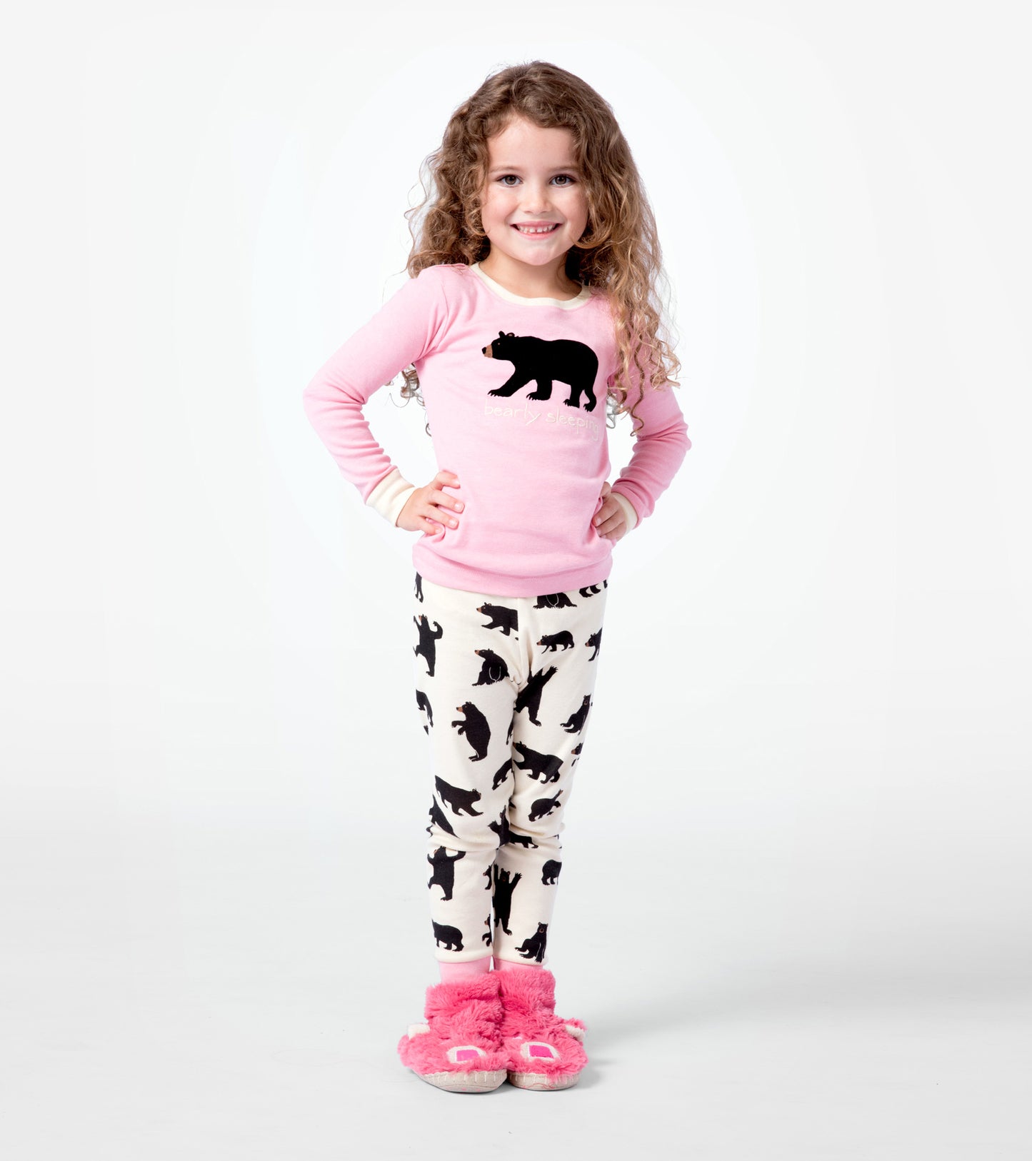 Pink long-sleeve pajama top with black bear graphic paired with cream pants featuring black bear silhouettes.