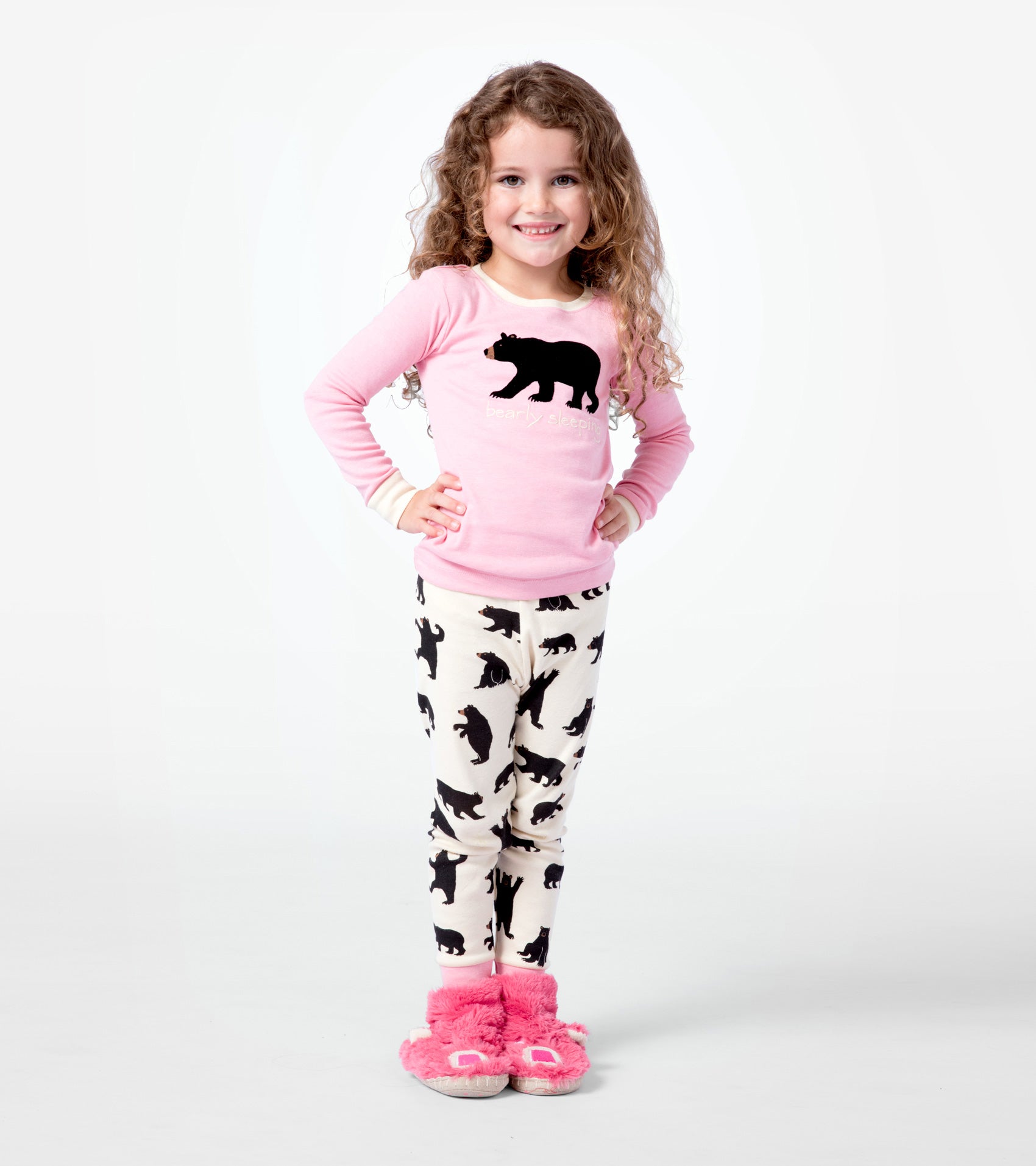 Pink long-sleeve pajama top with black bear graphic paired with cream pants featuring black bear silhouettes.