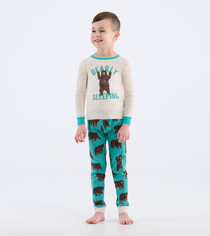 Tan long-sleeve top with bear graphic and turquoise accents, paired with turquoise pants featuring brown bear prints.