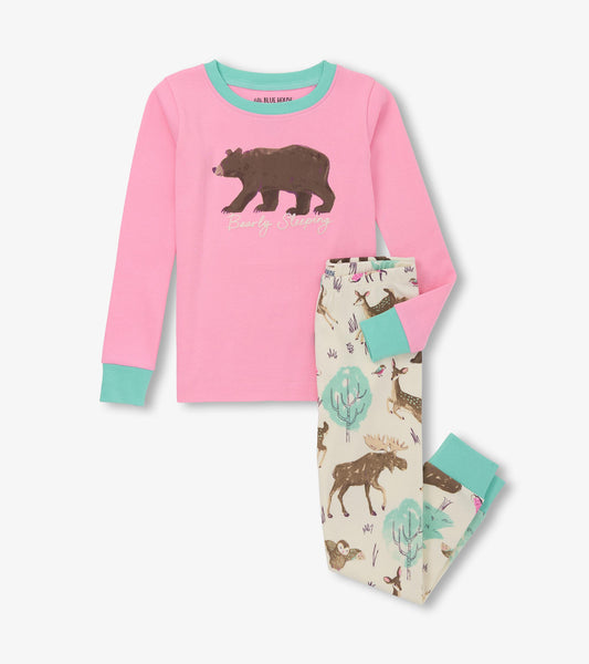 Pink long-sleeve pajama top with bear graphic, paired with cream pants featuring woodland animal prints and mint cuffs.