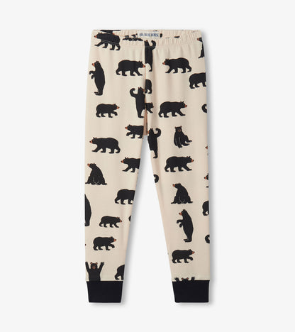 Beige pajama pants featuring a playful black bear pattern and black cuffs, ideal for cozy sleepwear.