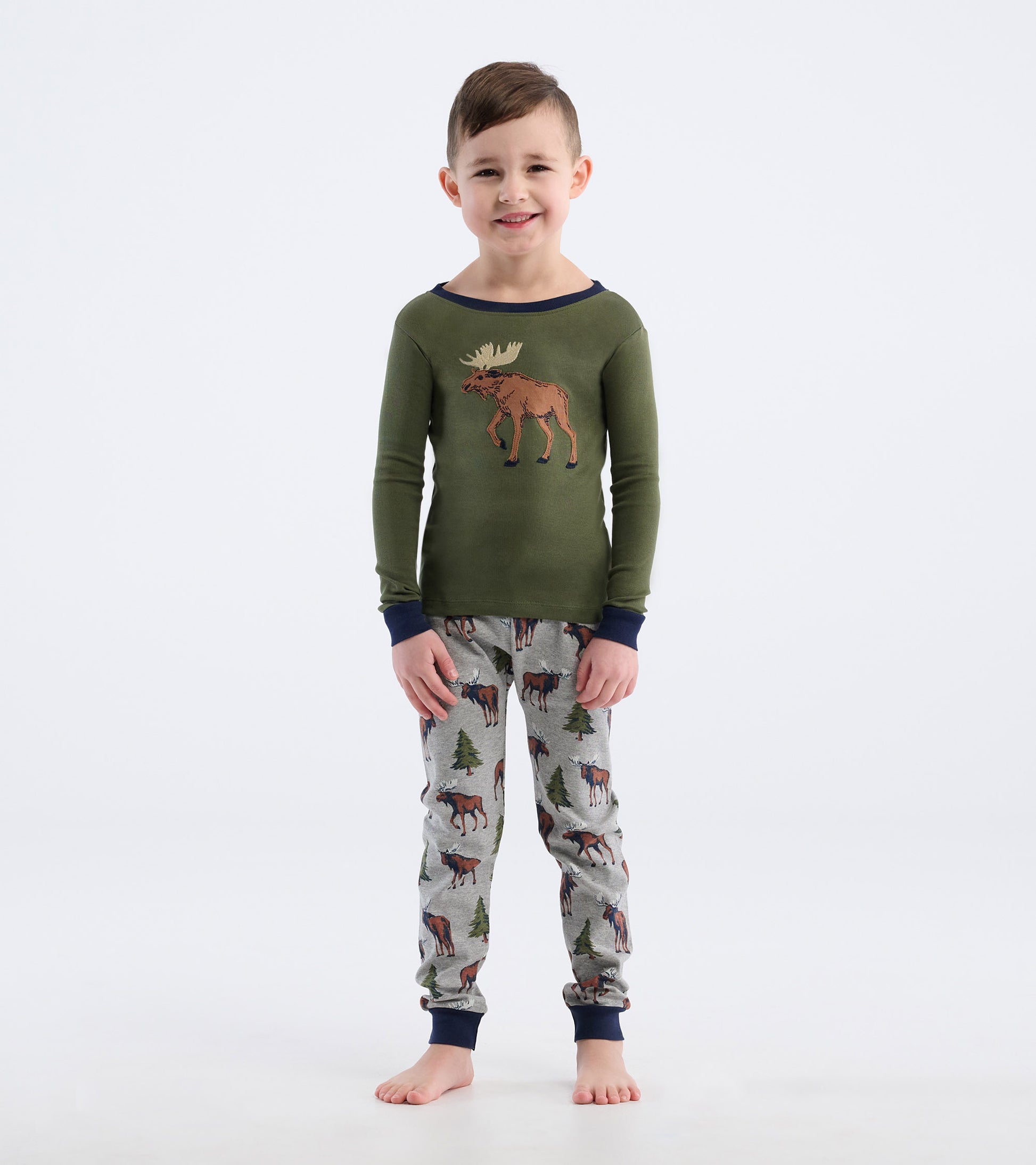 Green long-sleeve top with moose graphic, paired with gray pajama pants featuring moose and trees pattern.