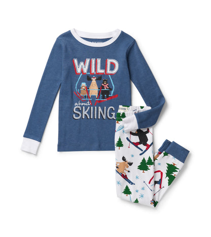 Blue kids pajama set with Wild About Skiing animal graphic top and white ski animal print pants