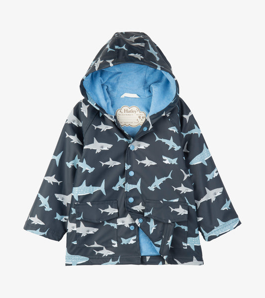 Kids navy raincoat with blue and white shark print, hood, front snaps, patch pockets, and blue lining