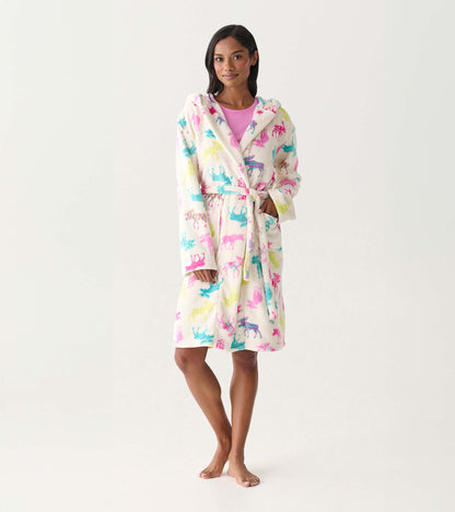 Women's white fleece robe with colorful moose print, hood, tie waist, and front pockets, worn on model