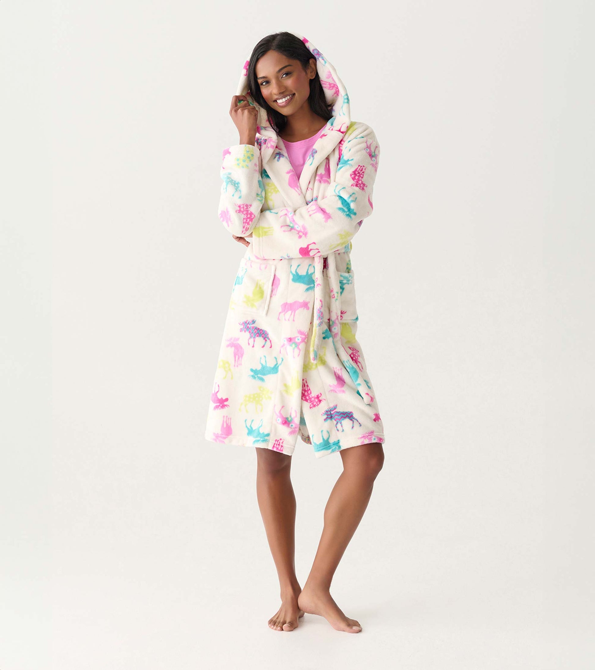 Woman wearing a cream fleece hooded robe with colorful moose print, front view, tied at the waist