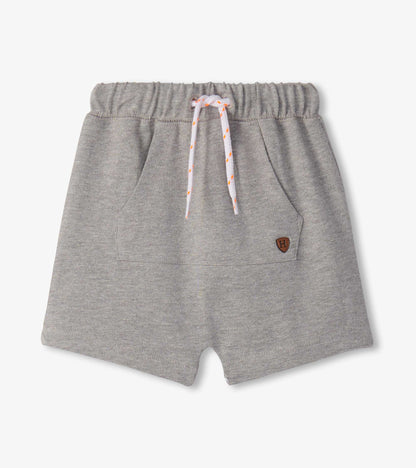 Grey knit toddler shorts with elastic waistband, drawstring, and front pocket patch, front view