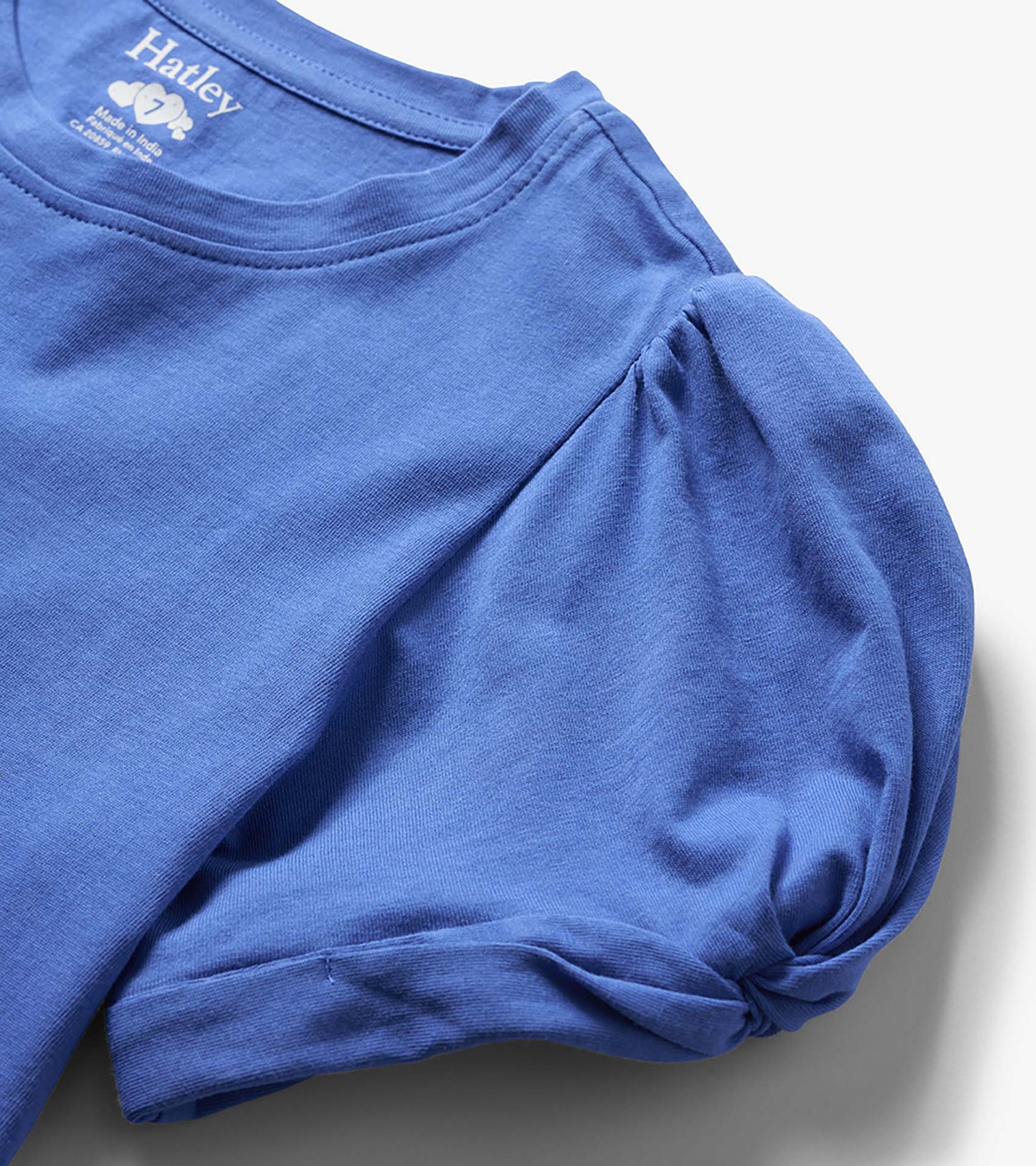 Blue girls long-sleeve T-shirt with twisted sleeve detail, folded close-up view