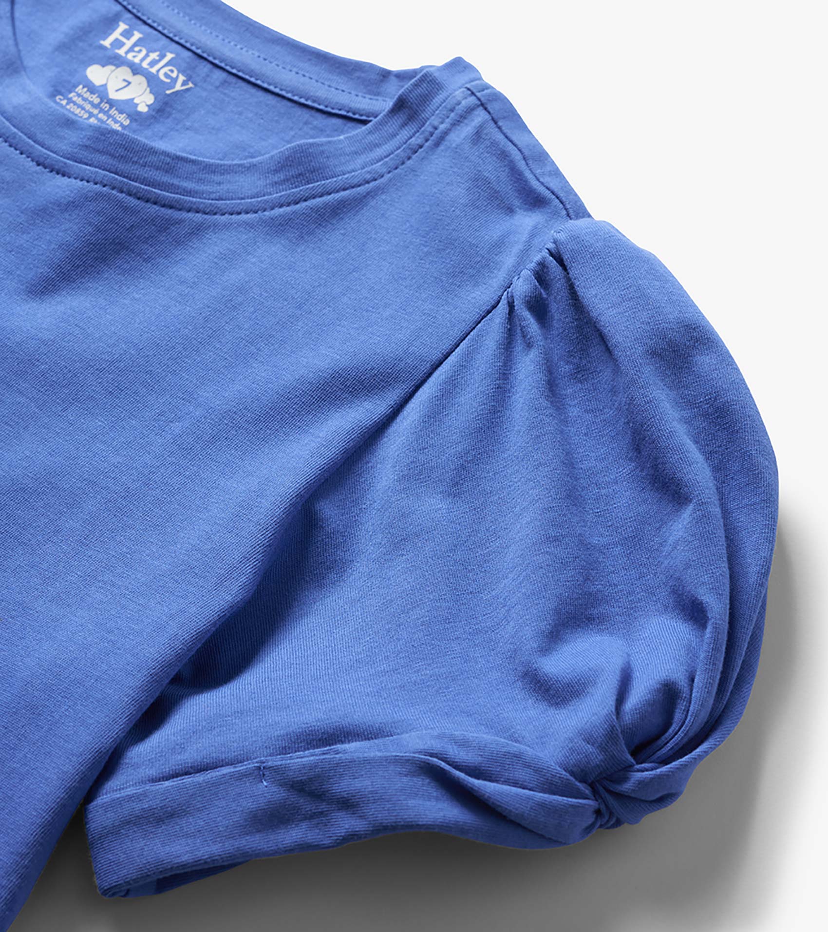 Blue girls long-sleeve T-shirt with twisted sleeve detail, folded close-up view