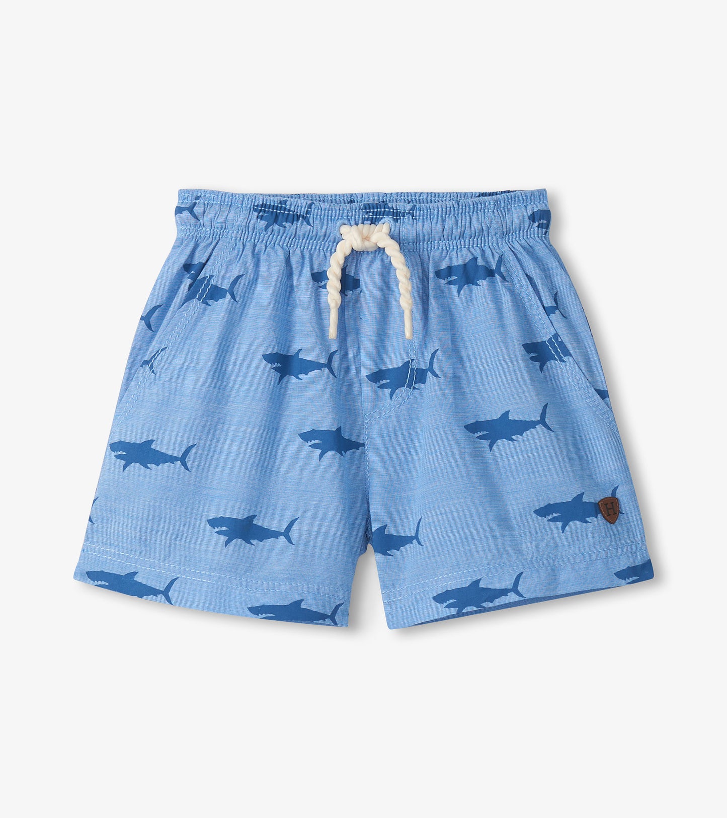 Light blue pull-on shorts with shark print, elastic waistband, and white drawstring, front view