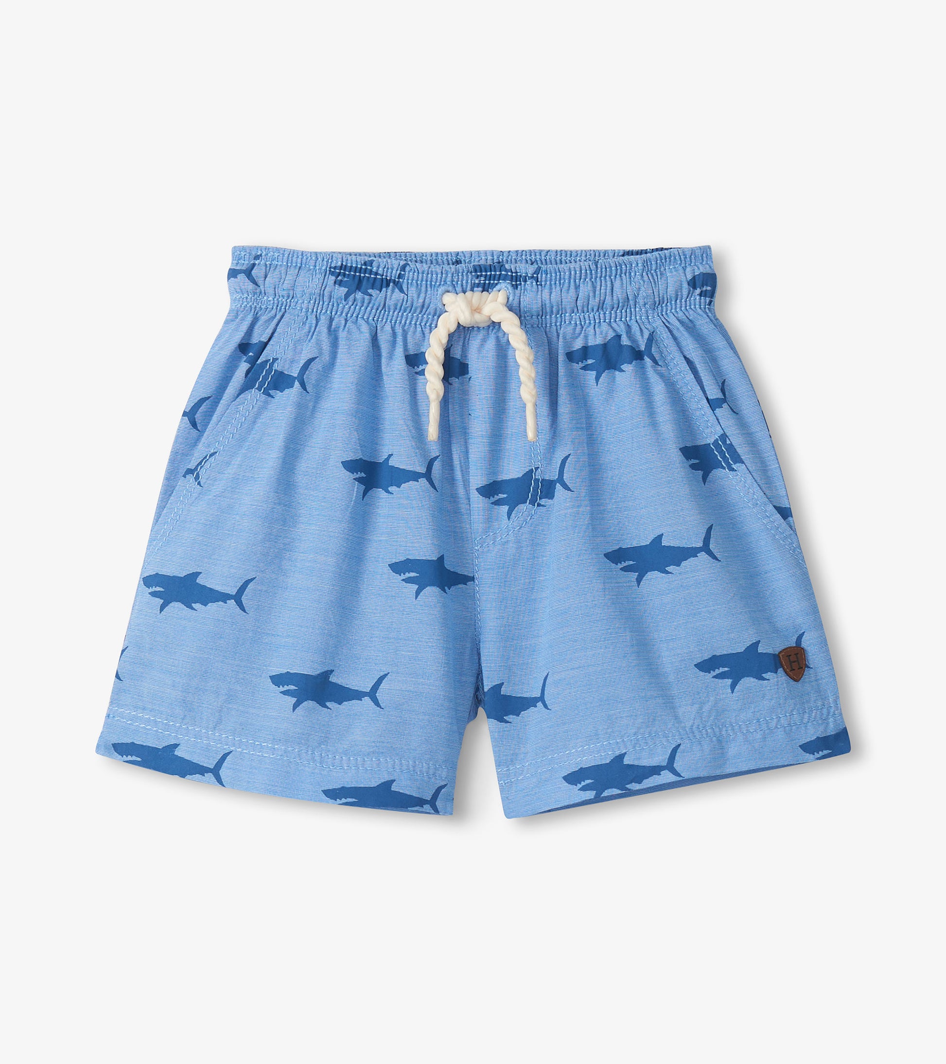 Light blue pull-on shorts with shark print, elastic waistband, and white drawstring, front view