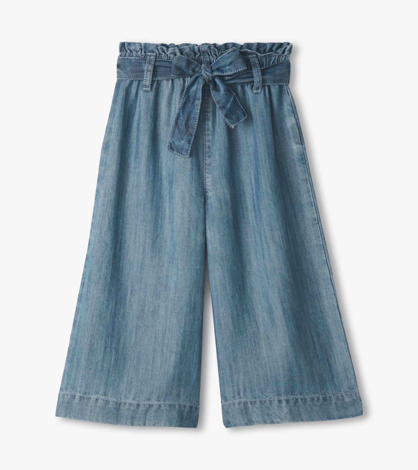 Girls smokey blue wash cropped paperbag pants with wide legs and tied waist, front view