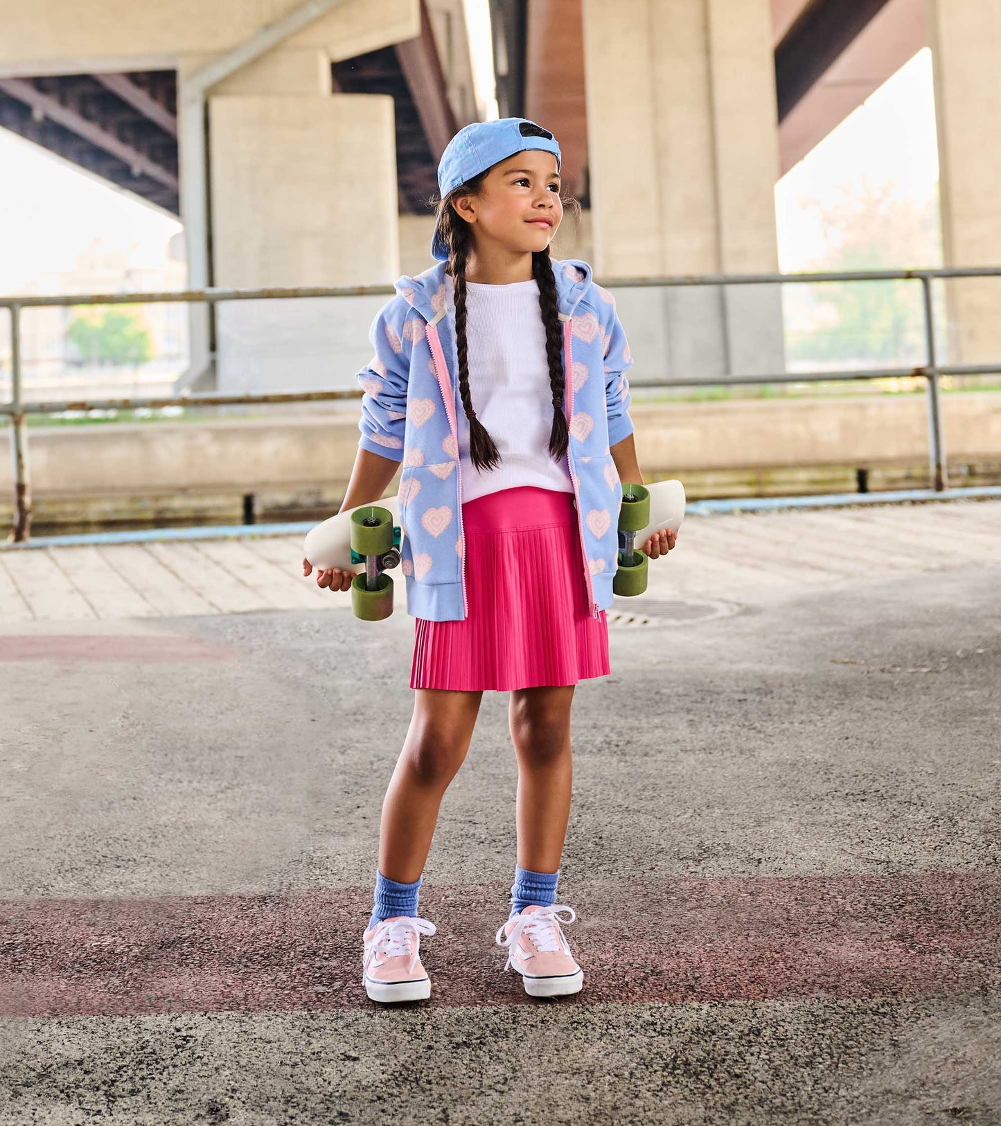 White girls tank top with ruffle sleeves, worn under a blue hoodie and pink skirt on a child model