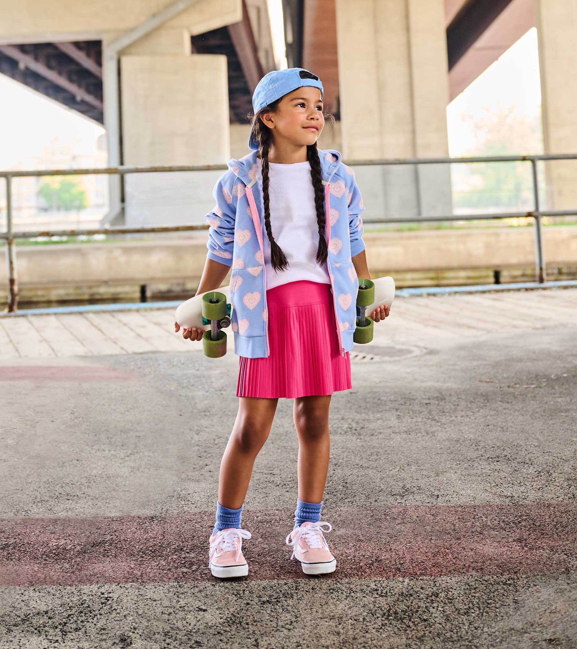 White girls tank top with ruffle sleeves, worn under a blue hoodie and pink skirt on a child model