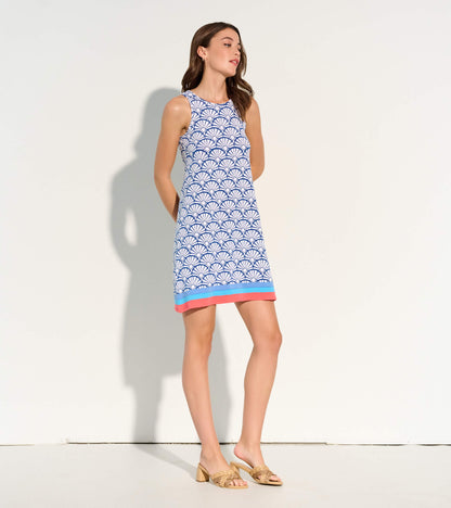 Angled view of Bella sleeveless dress in blue and white fan print with coral and blue hem