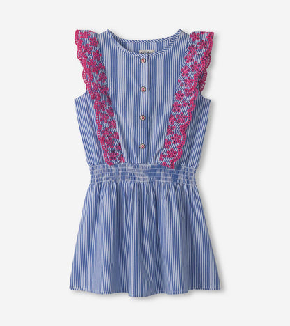 Blue and white pinstripe dress with pink ruffle detailing and buttons, featuring a smocked waist for a comfortable fit.
