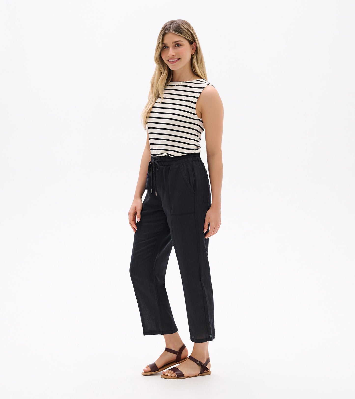 Black straight-leg linen pants with elastic waist and drawstring, shown on a model, front view