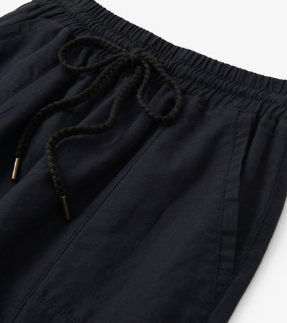 Black linen pants with elastic waistband and braided drawstring, close-up detail view