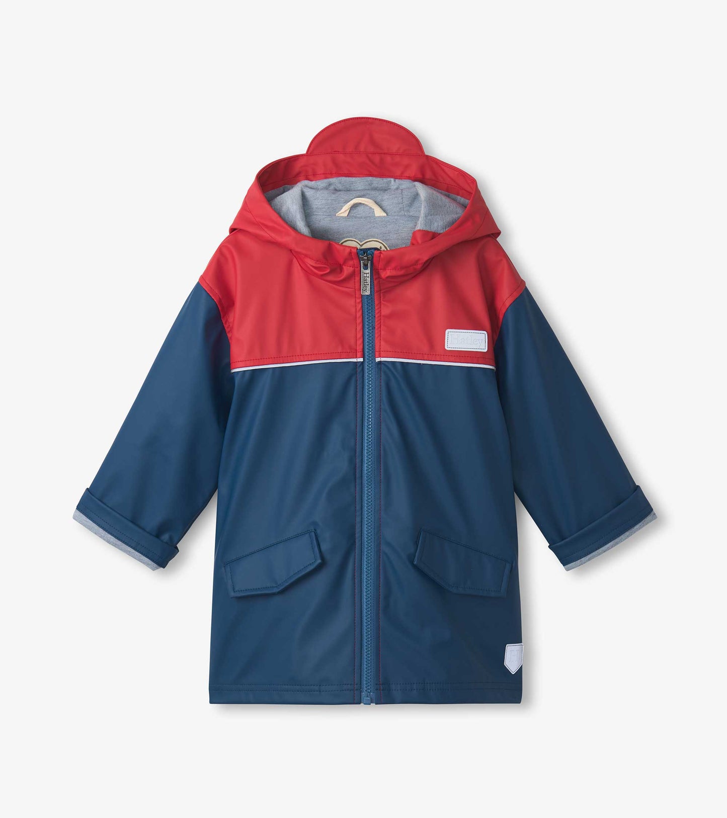 Front view of a red and navy boys' zip-up rain jacket with hood and flap pockets