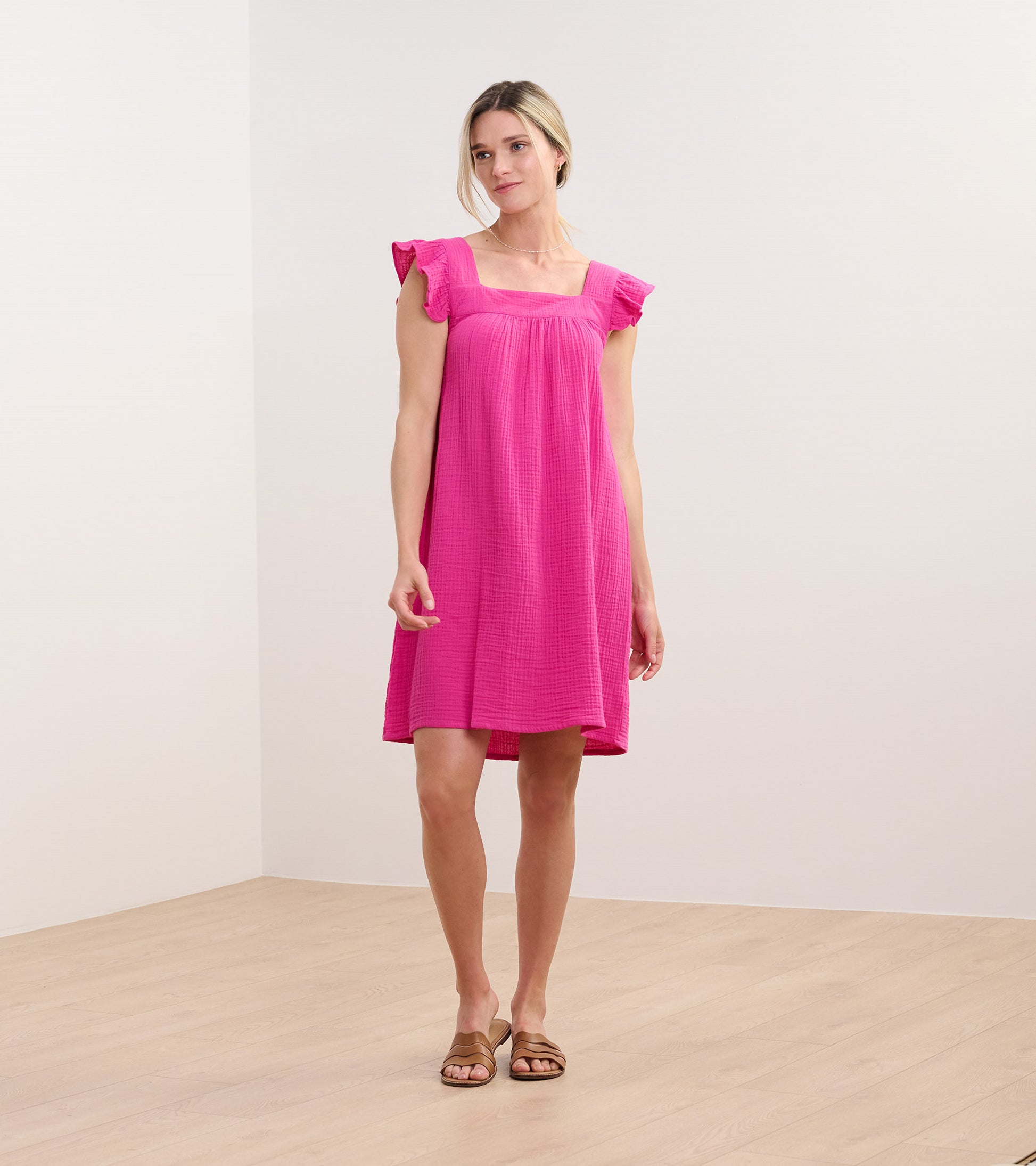 Bright fuchsia sleeveless dress with flutter sleeves, square neckline, and relaxed knee-length fit on model