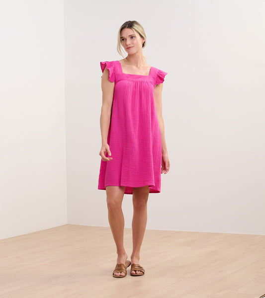 Bright fuchsia sleeveless dress with flutter sleeves, square neckline, and relaxed knee-length fit on model