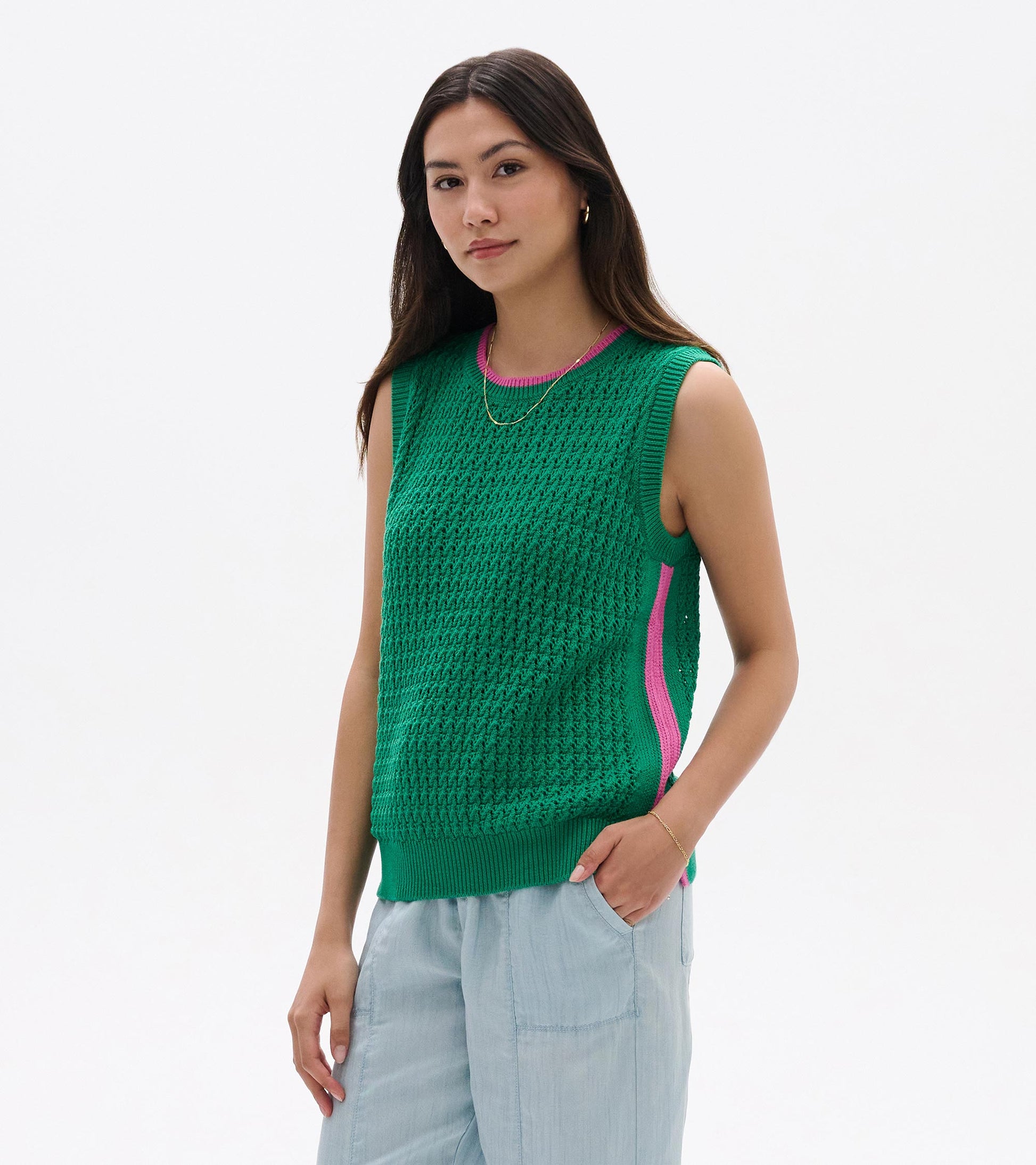 Green knit sleeveless tank top with pink trim and side stripe, worn with light blue pants, front view
