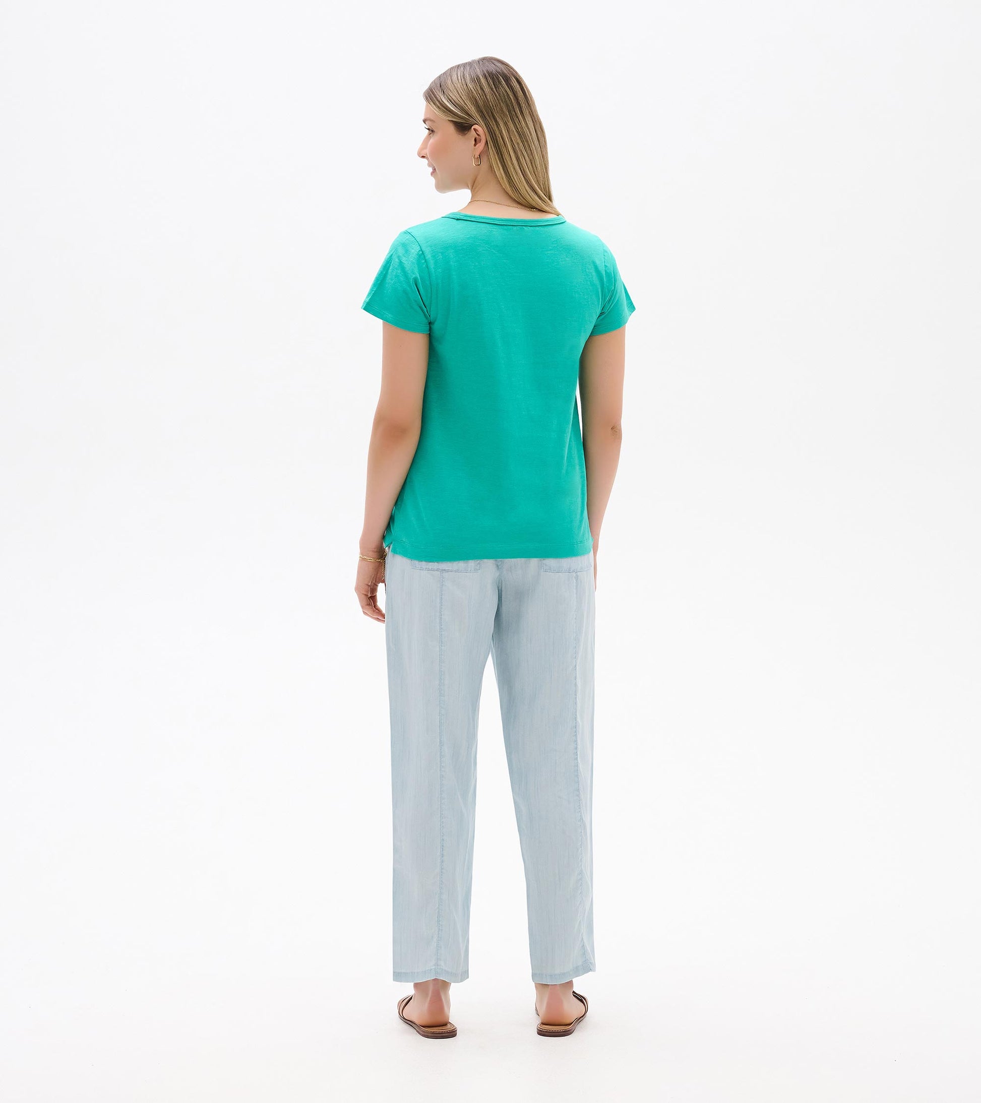 Teal short-sleeve crew neck T-shirt shown from the back on a model