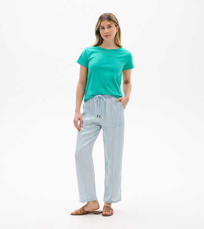 Turquoise short-sleeve crew neck tee on a model, front view, with a smooth cotton look.